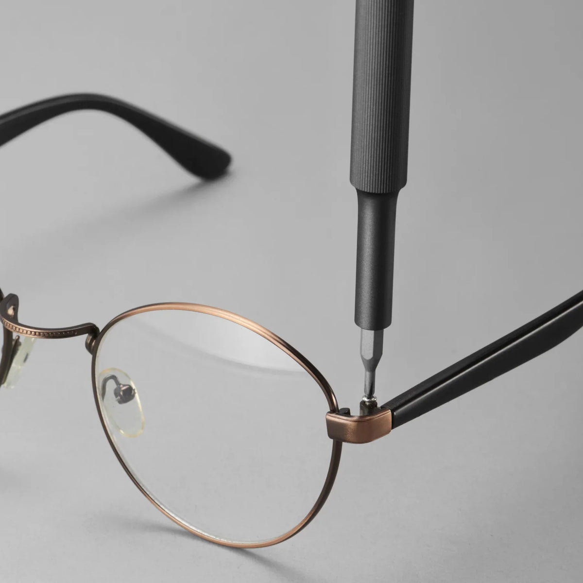 HOTO precision screwdriver tightening a glasses hinge