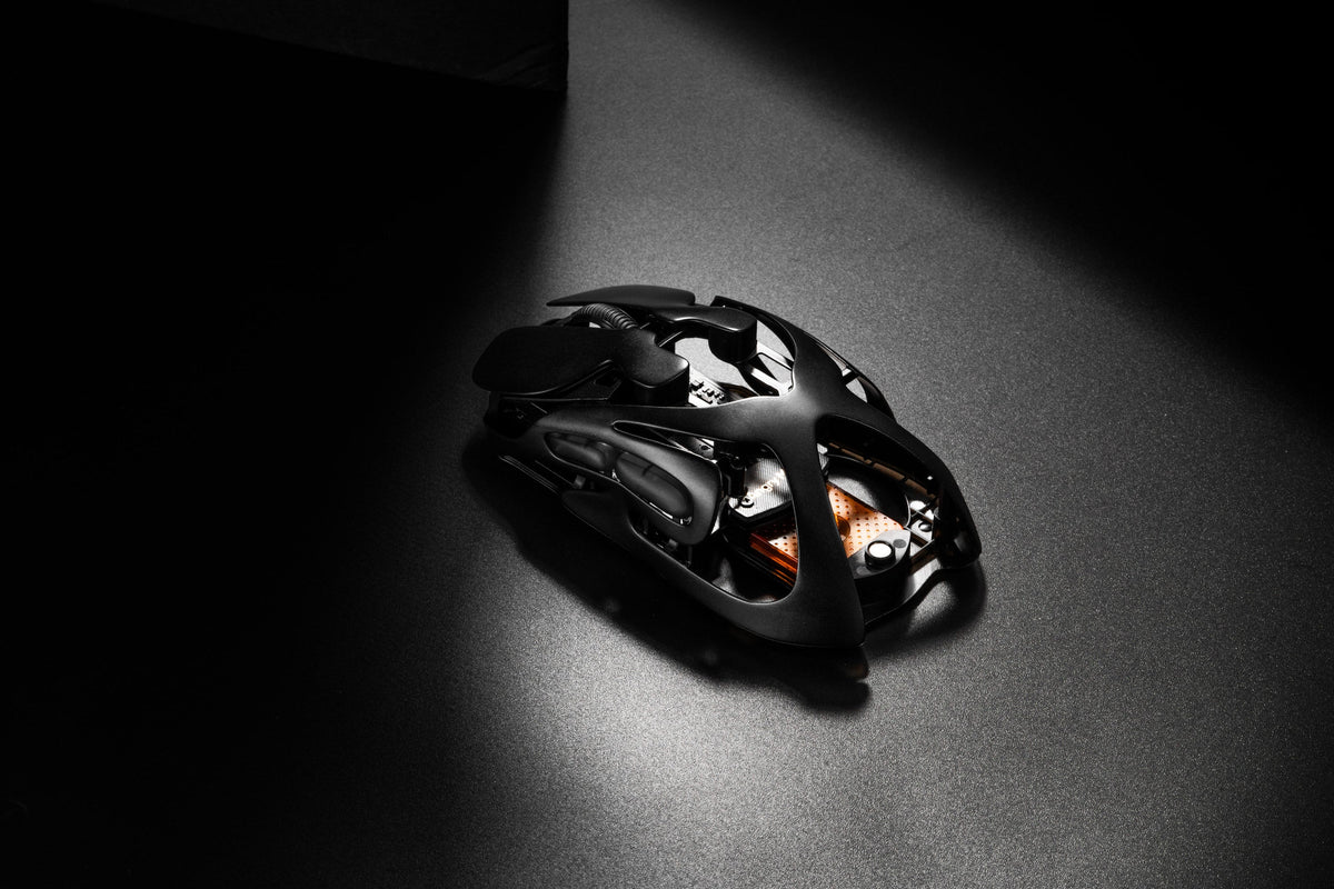 AM Infinity Mouse Basalt Black at an angle, showing the hollow metal shell