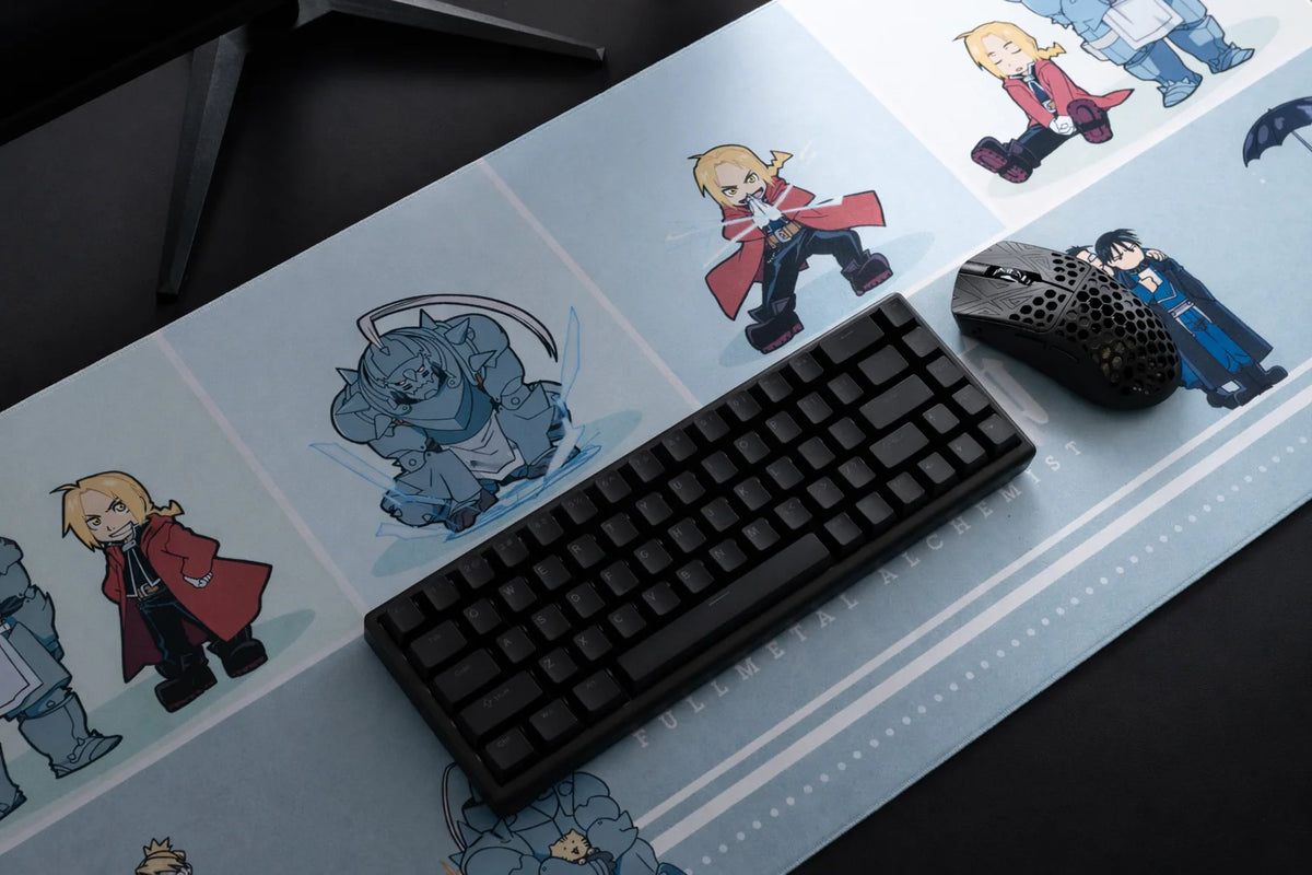 Chibi Alchemists XL cloth mousepad on a desk with a keyboard and gaming mouse
