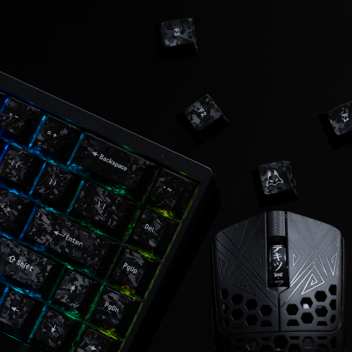 Carbon fibre textured keycaps on an RGB keyboard next to a gaming mouse