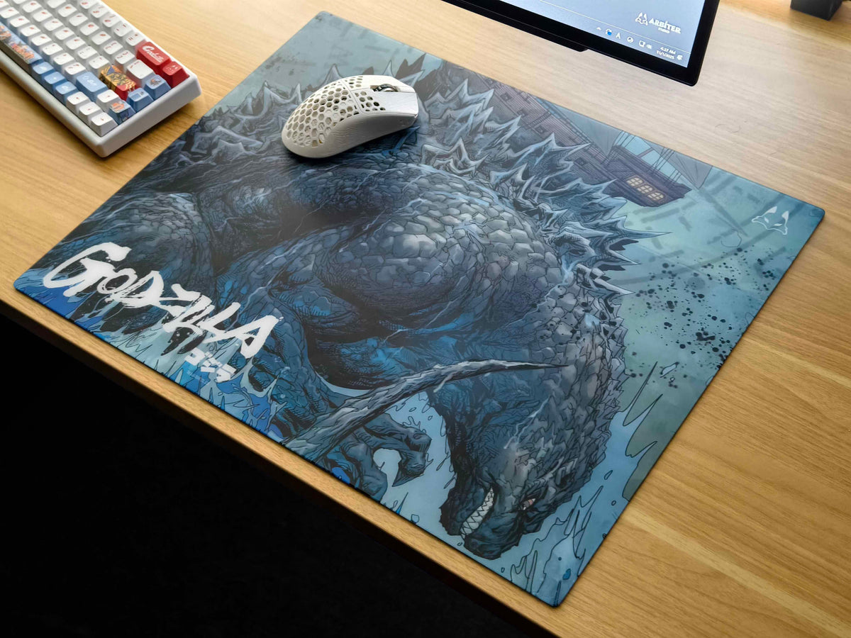 Godzilla 2.0 Shipwreck glass mousepad on a wooden desk with a keyboard and mouse